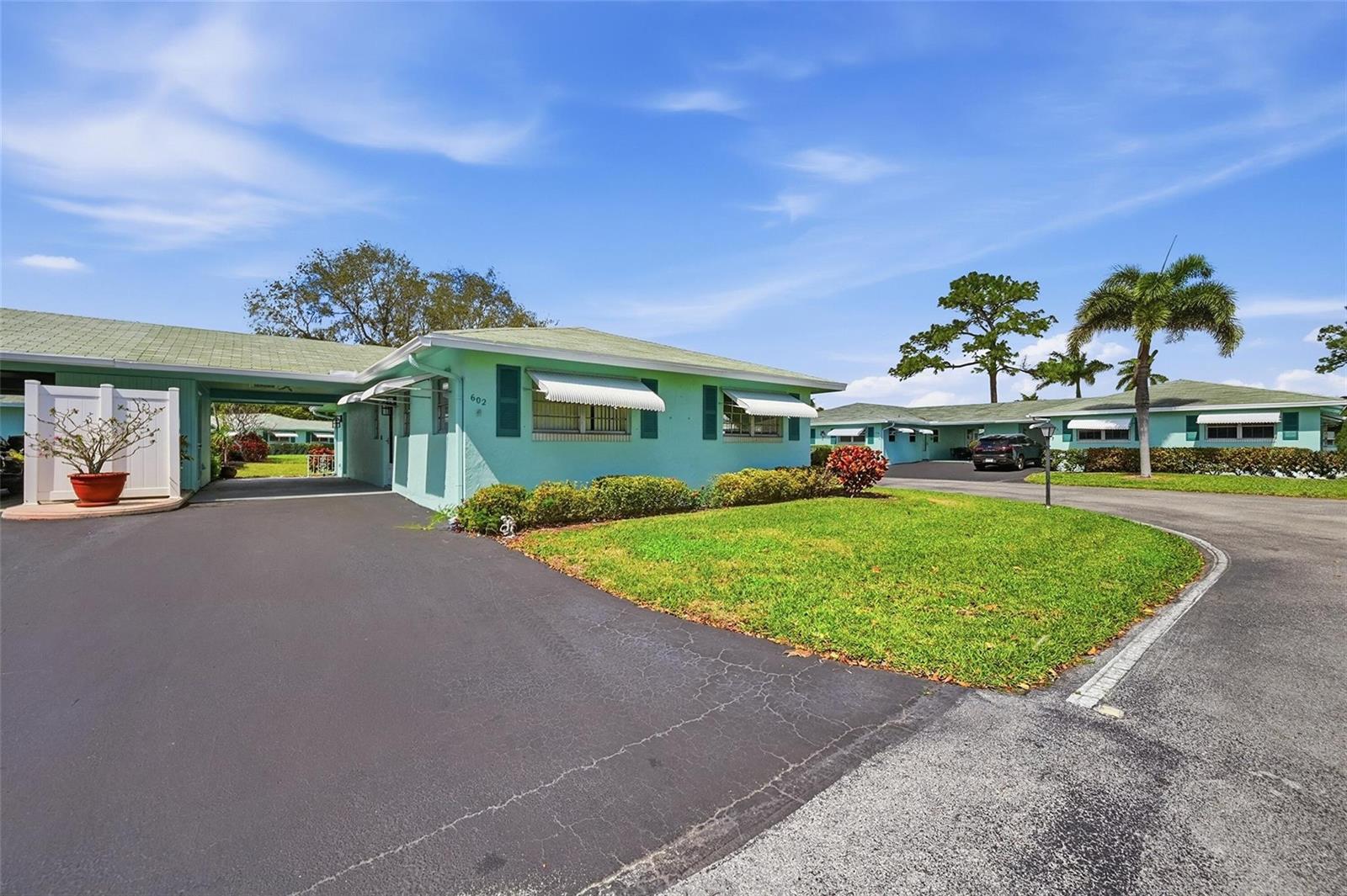 A light green single-story building with a covered carport and a paved driveway — 602 Hummingbird Lane # 602, Delray Beach FL 33445, DELRAY BEACH, FL