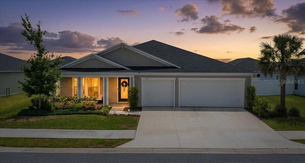 A single-story suburban house with a two-car garage, covered porch, and a landscaped front yard — 9329 SW 57TH TERRACE, OCALA, FL
