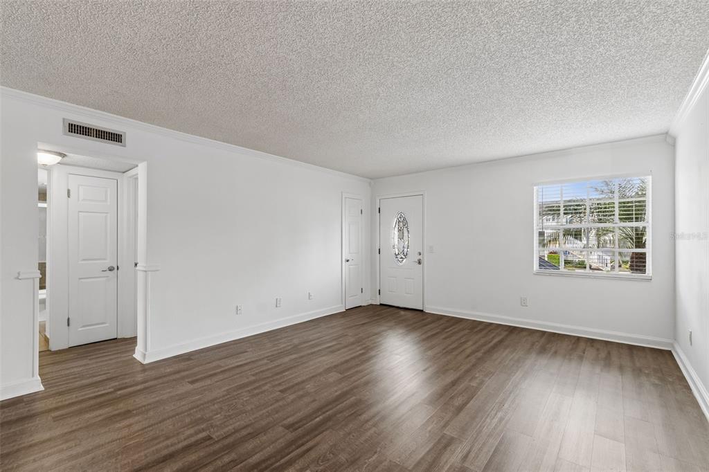 A swimming pool with lounge chairs and a pergola sits before a multi-story apartment building — 4813 MCELROY UNIT D108, TAMPA, FL