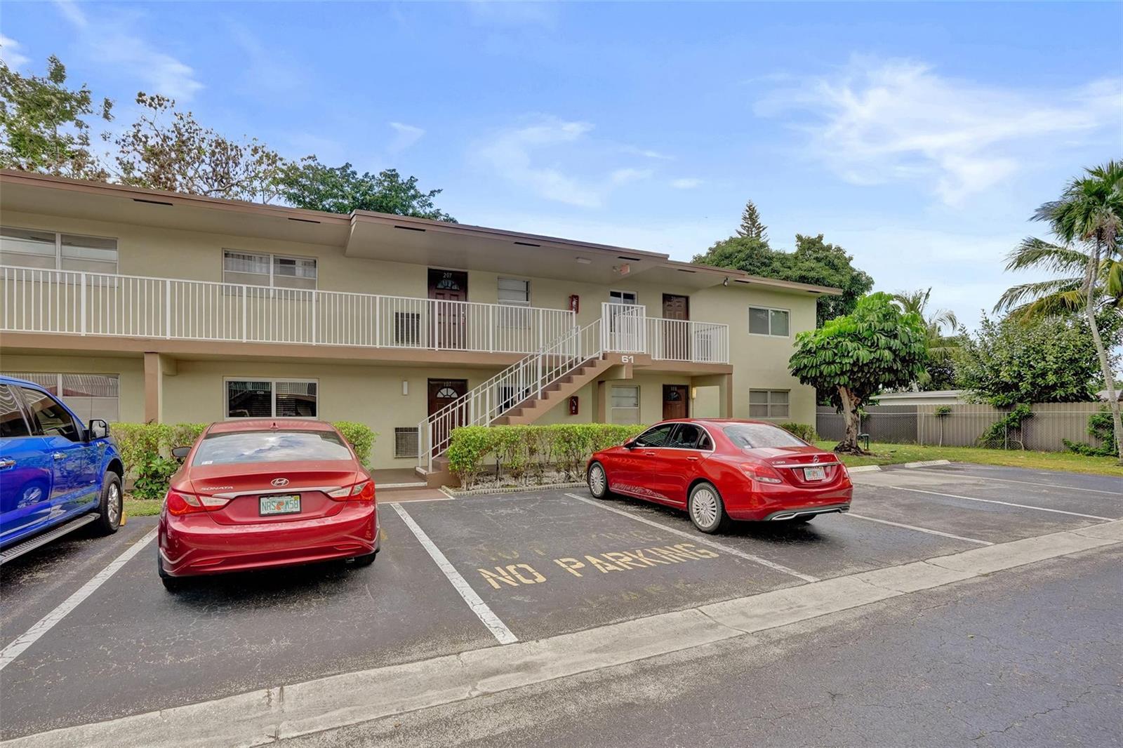A two-story apartment building with a parking lot in front and a central staircase — 651 NW 80th Terrace # 207, Margate FL 33063, MARGATE, FL