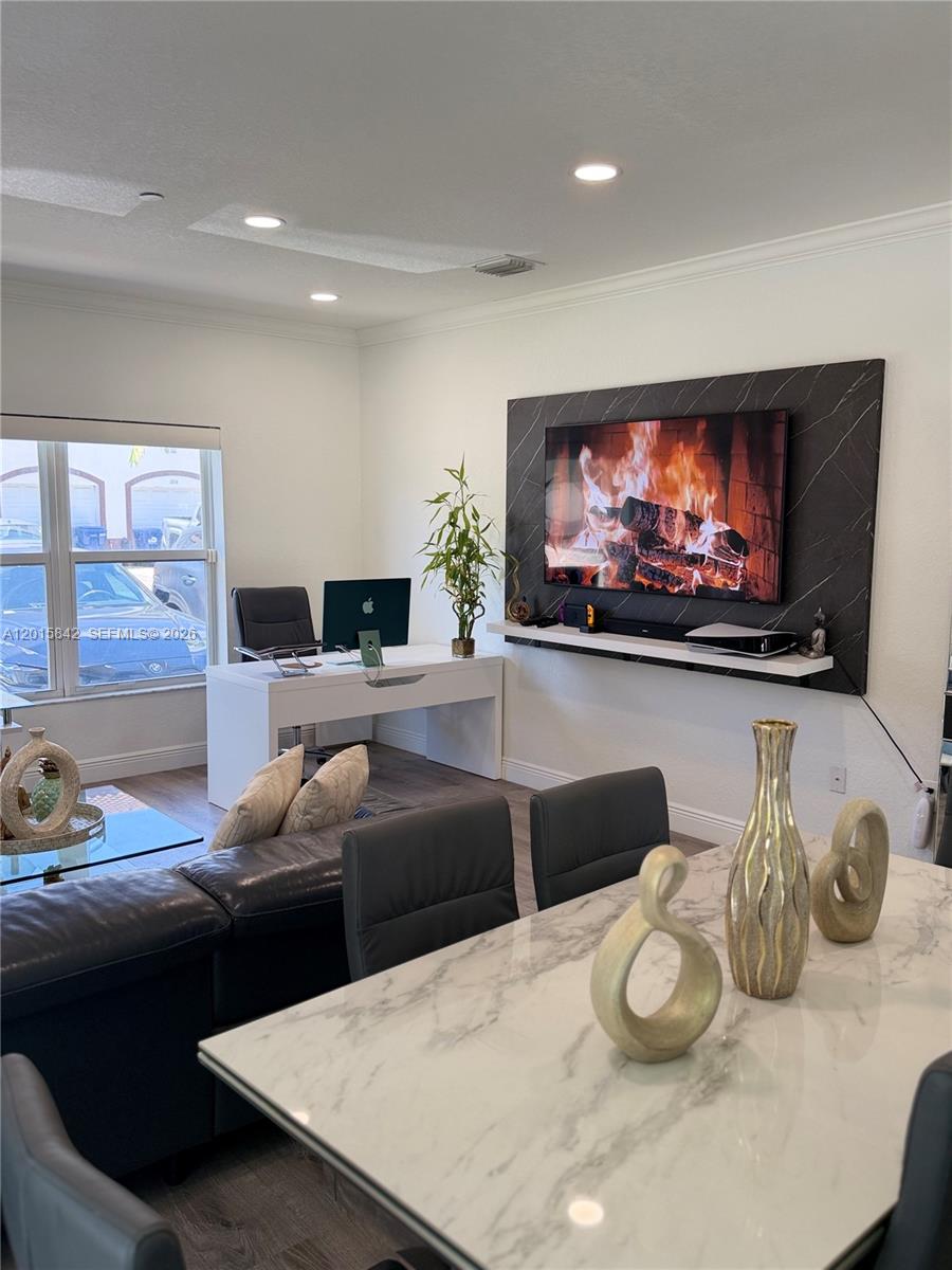 A living room features a wall-mounted television, a desk, and a dining table — 2824 SW 145th Ct # 2824, Miami FL 33175, MIAMI, FL