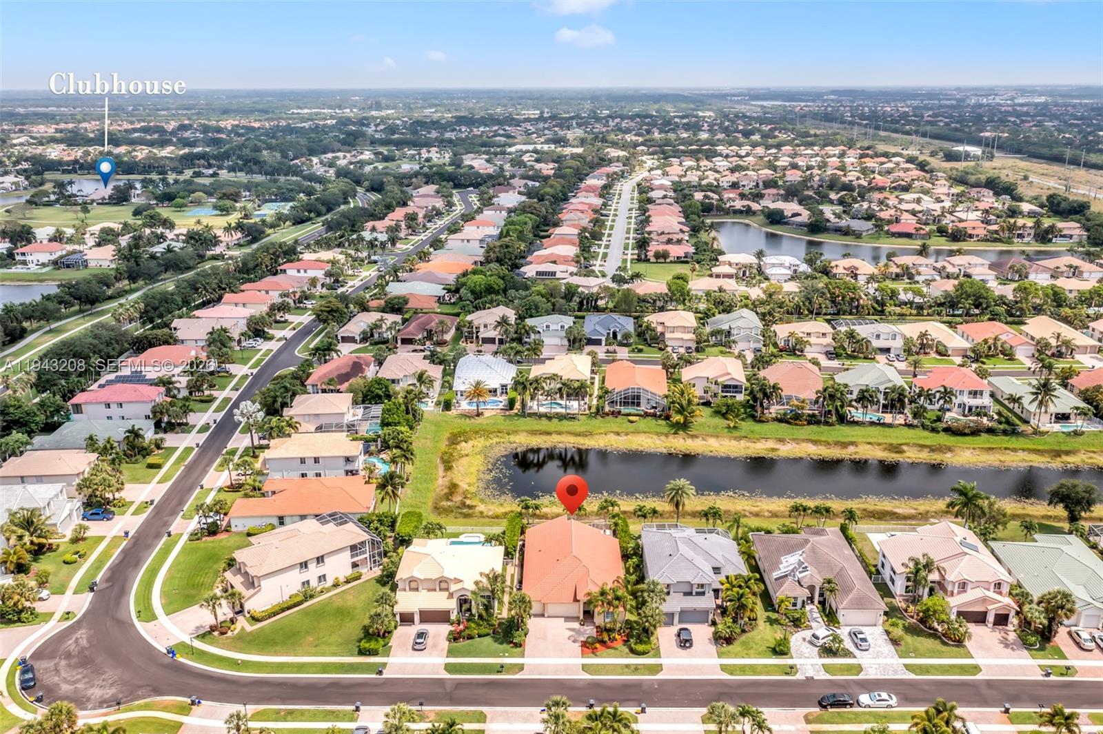 An aerial view shows a residential neighborhood with houses, a lake, and a clubhouse — 11223 Maritime Ct, Wellington FL 33449, WELLINGTON, FL
