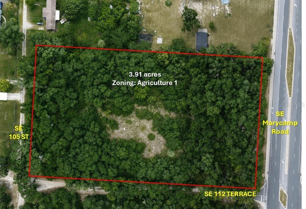 This aerial map shows a rectangular, tree-covered 3.91-acre lot outlined in red — SE 112 TERRACE, OCALA, FL