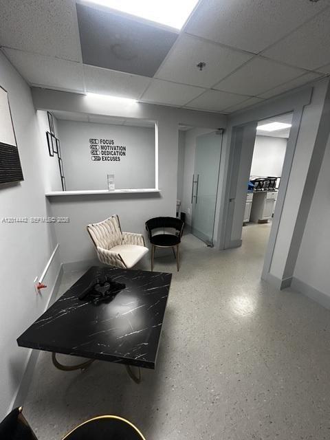 A waiting area features a black marble coffee table, two chairs, and a motivational wall decal — 900 W 49th St Suite B001, Hialeah FL 33012, HIALEAH, FL