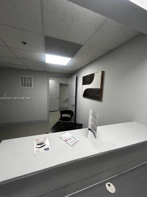 A reception desk sits in the foreground of a room with a doorway and artwork — 900 W 49th St Suite B001, Hialeah FL 33012, HIALEAH, FL