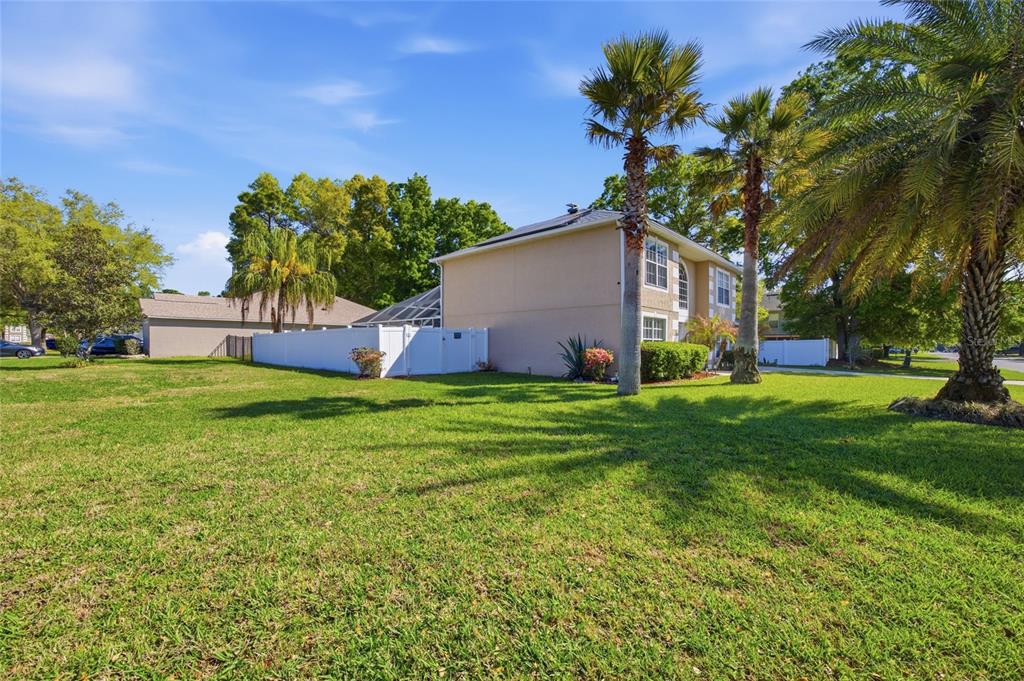 A two-story house with a white fence and palm trees sits on a grassy lawn — 4517 SE 28TH STREET, OCALA, FL