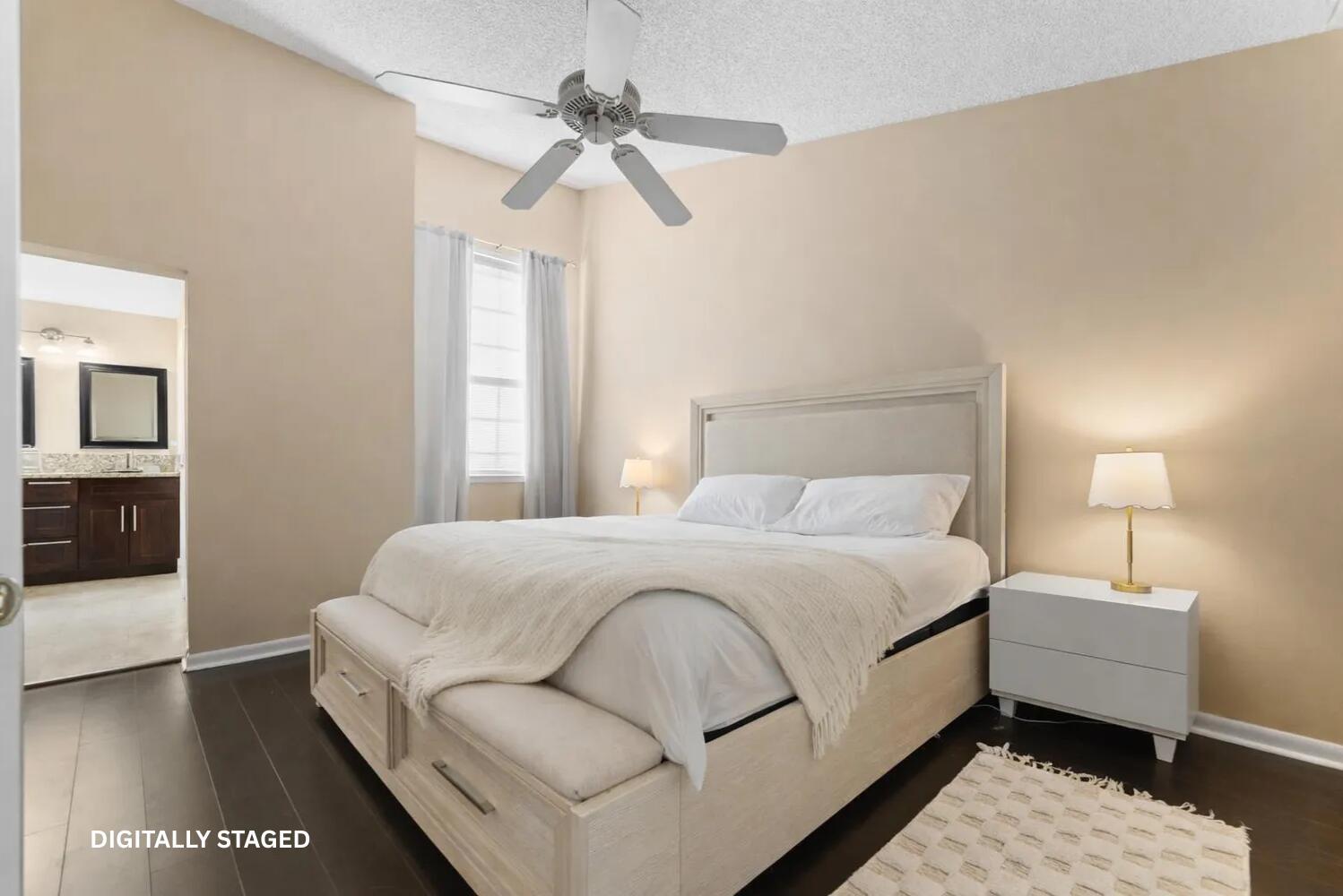 A digitally staged bedroom features a light-colored bed, white nightstand, and dark wood flooring — 5359 Buckhead Circle # 2031, Boca Raton FL 33486, BOCA RATON, FL