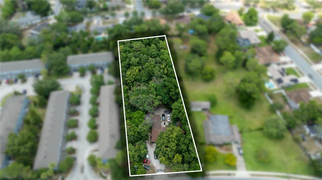 An aerial view shows a wooded residential lot with a house and driveway — 761 SEMINOLA BOULEVARD, CASSELBERRY, FL