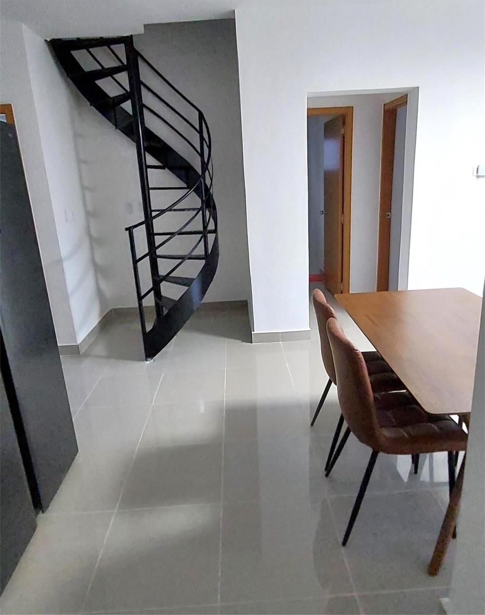 A dining area features a black spiral staircase, light tile flooring, and two brown chairs — Calle 6 Calle 6, Punta Del Este 2 # C301, FL