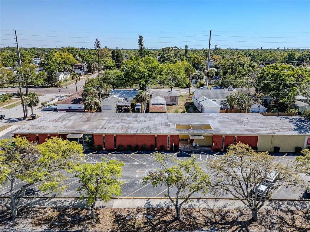An aerial view shows a long, single-story commercial building with a flat roof and parking — 4200 CENTRAL AVENUE S, ST PETERSBURG, FL