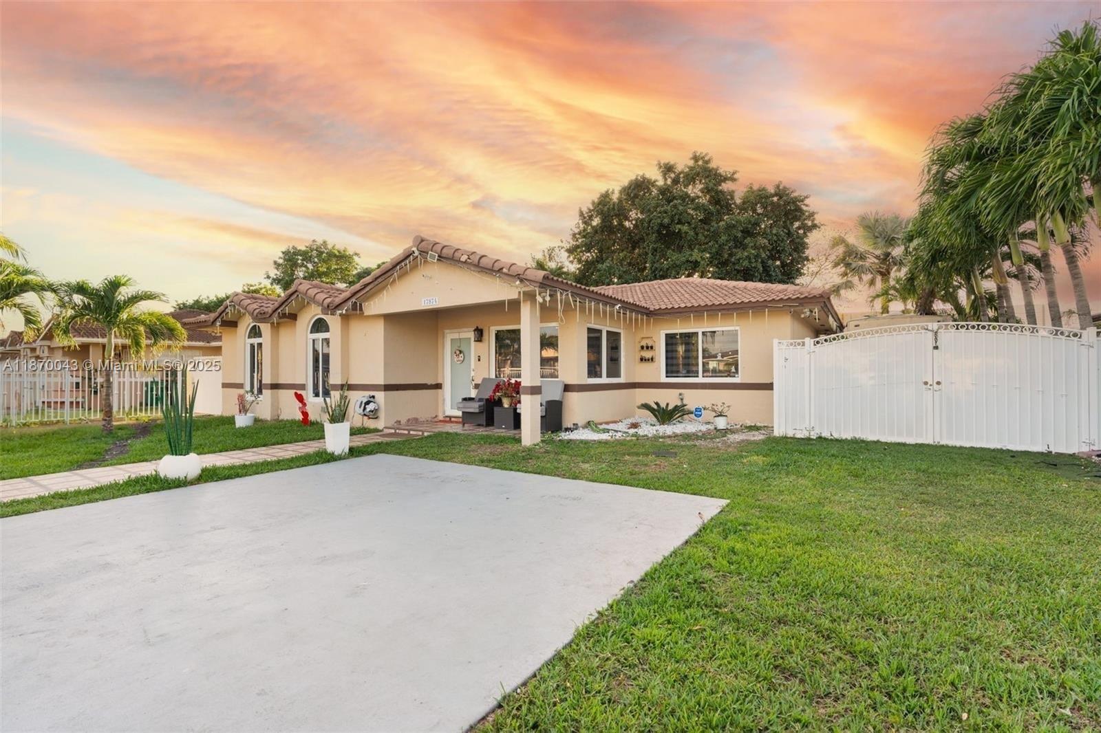 A single-story house with a beige stucco exterior, tile roof, and a concrete driveway — 17874 SW 114th Ave, Miami FL 33157, MIAMI, FL