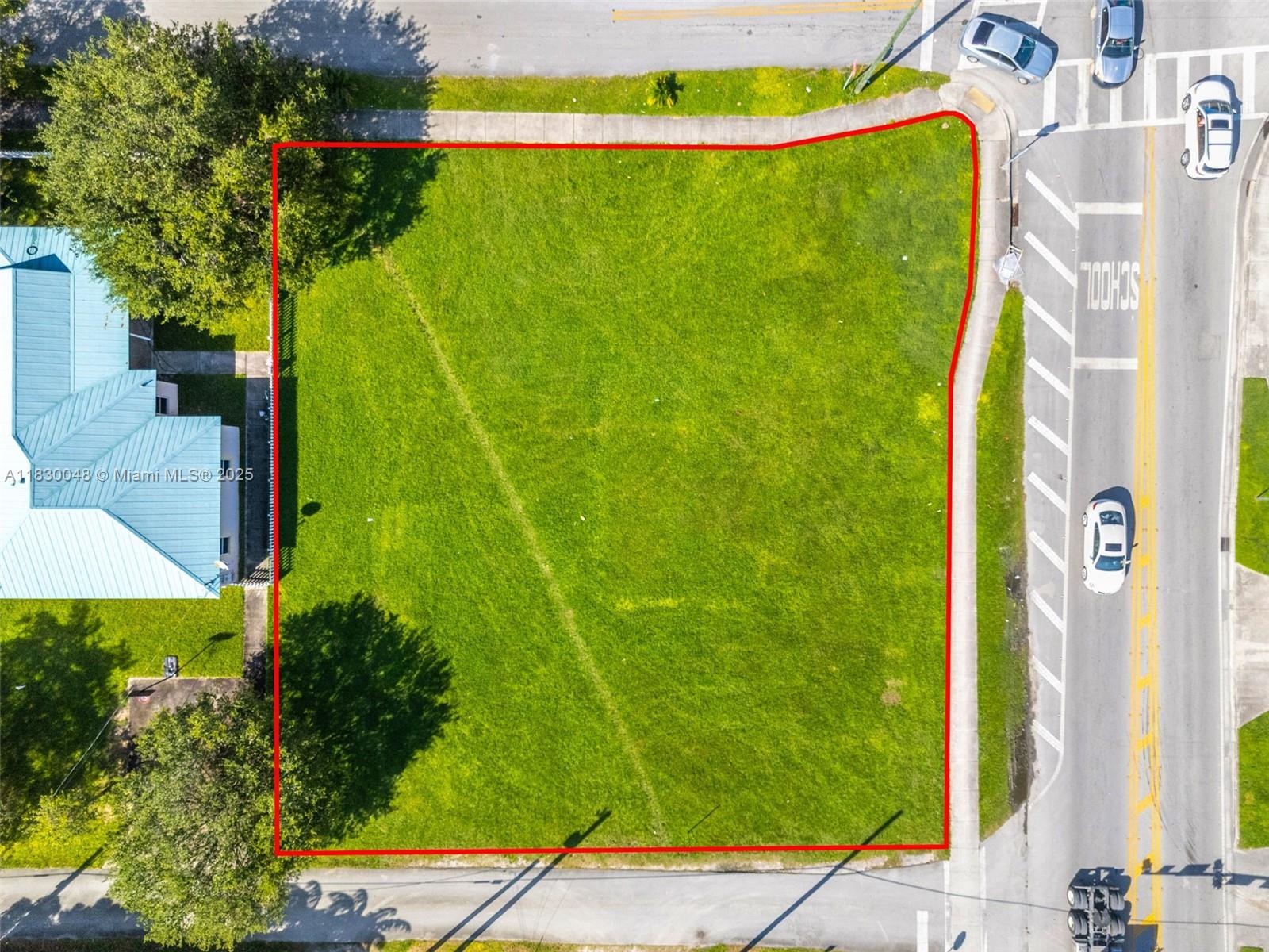 An aerial view shows a vacant, rectangular grass lot outlined in red next to a road — 604 SW 6th Ave, Homestead FL 33030, HOMESTEAD, FL