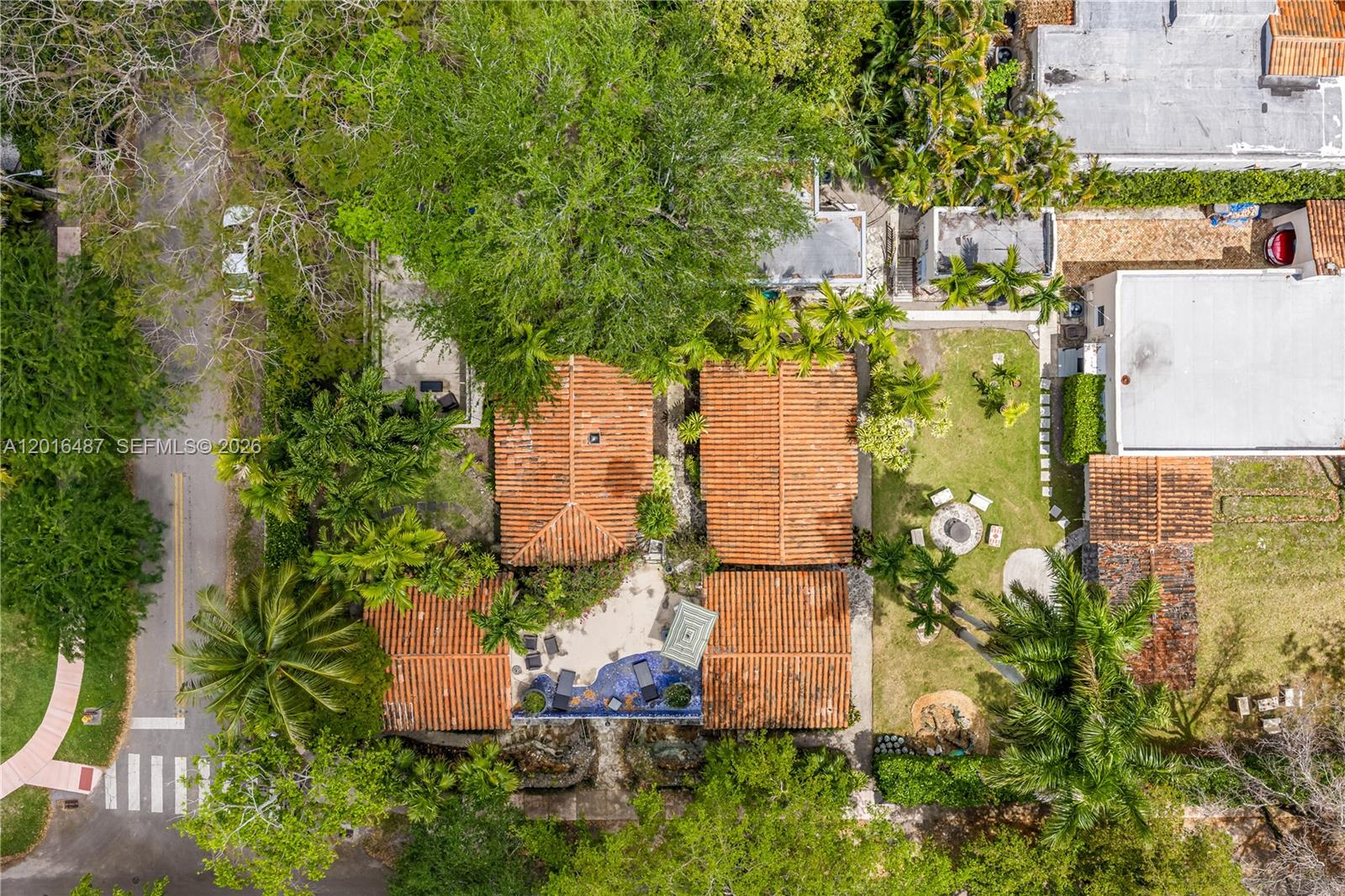 An aerial view shows a house with a tiled roof, pool, and backyard patio area — 1301 Milan Ave # 3, Coral Gables FL 33134, CORAL GABLES, FL