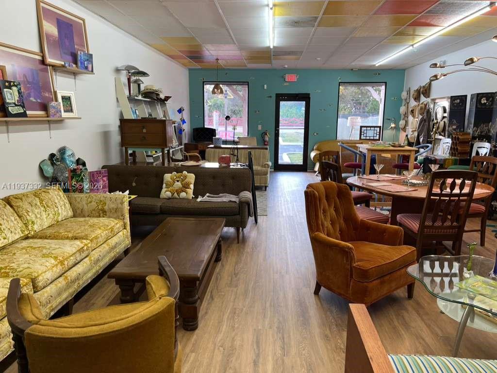 A retail space features vintage furniture, a patterned drop ceiling, and a teal accent wall — 4264 SW 64th Ave, Davie FL 33314, DAVIE, FL