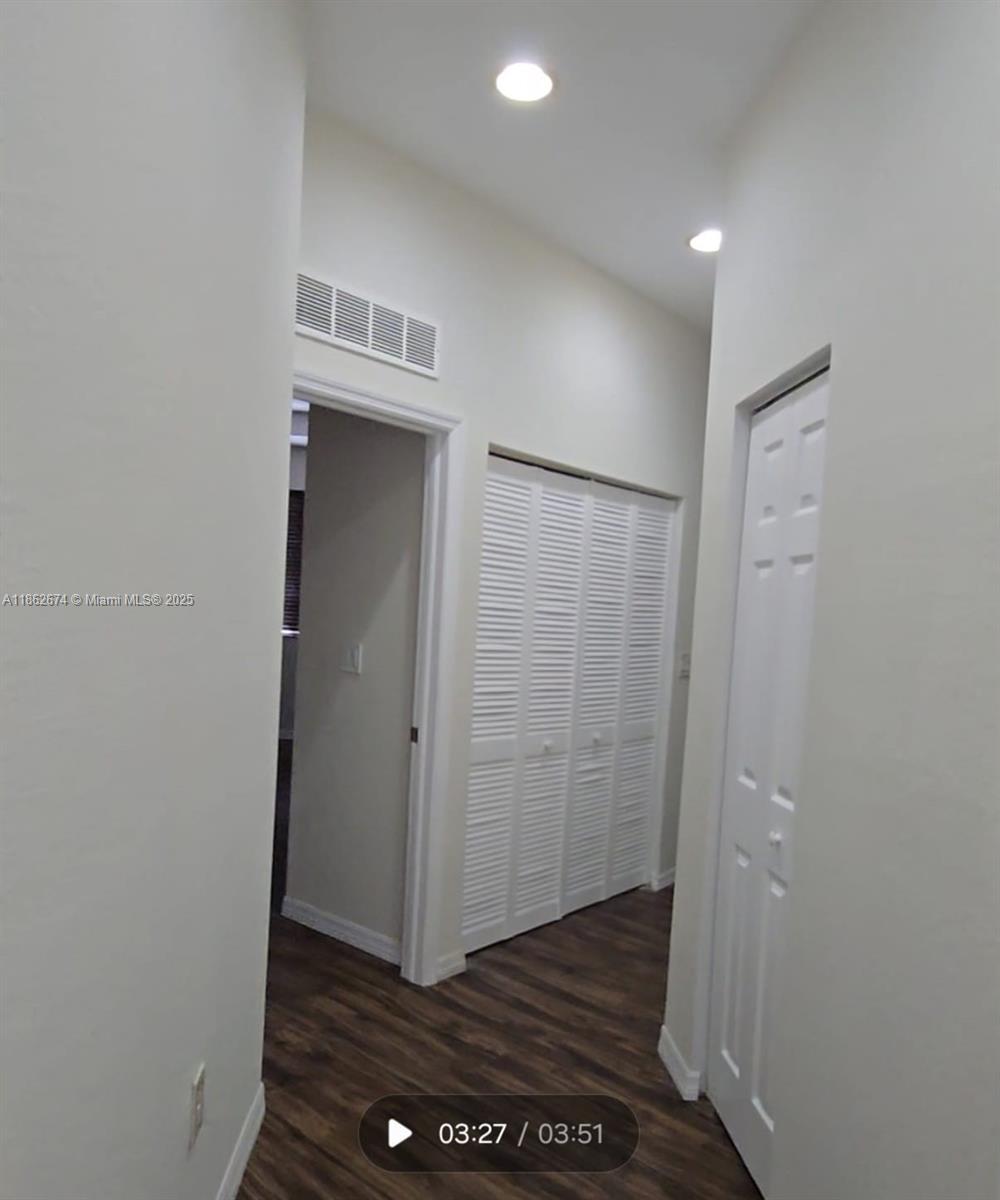 A hallway features wood-look flooring, white walls, recessed lighting, and several white closet doors — 4917 SW 141st Ave # 4, Miramar FL 33027, MIRAMAR, FL