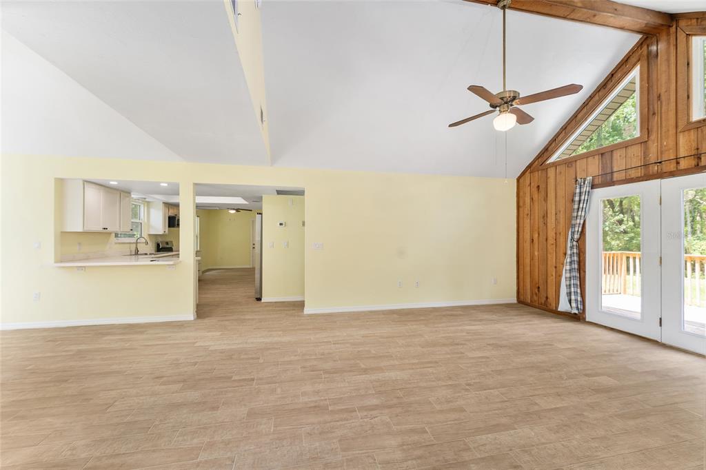 A kitchen with white cabinets, stainless steel appliances, and light yellow walls — 813 SW 99TH STREET, GAINESVILLE, FL