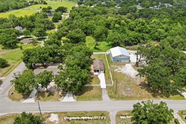 An aerial view shows a house and a large detached garage on a rural lot — 1140 S FLORIDA AVENUE, WAUCHULA, FL