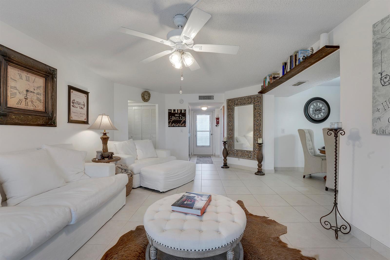 A living room with white furniture, a tufted ottoman, a ceiling fan, and tiled floors — 3755 Via # 405, Lake Worth FL 33467, LAKE WORTH, FL