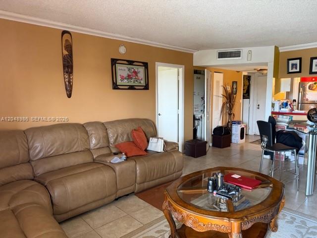 A living room features a large tan leather sectional sofa and a round glass coffee table — 4174 Inverrary Dr # 605, Lauderhill FL 33319, LAUDERHILL, FL