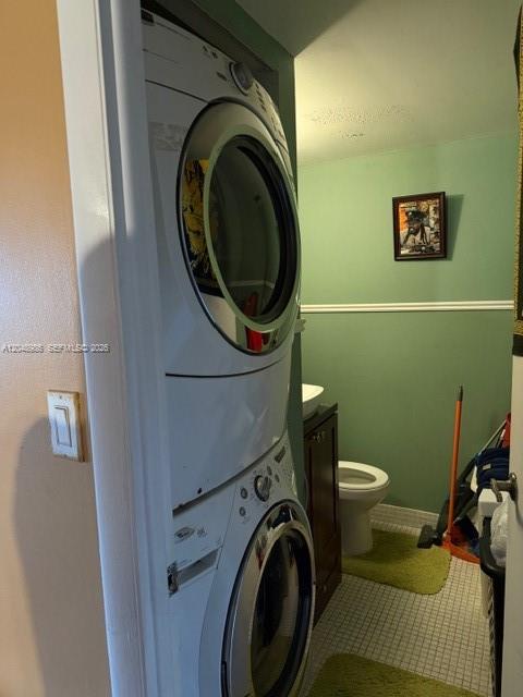 A stacked washer and dryer unit stands in a small bathroom with green walls — 4174 Inverrary Dr # 605, Lauderhill FL 33319, LAUDERHILL, FL