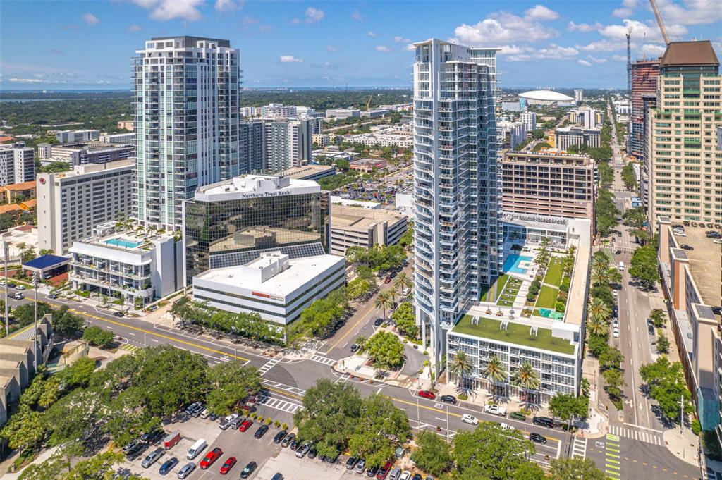 An aerial view of a city street featuring two tall residential towers and surrounding buildings — 175 1ST STREET S UNIT 1204, ST PETERSBURG, FL