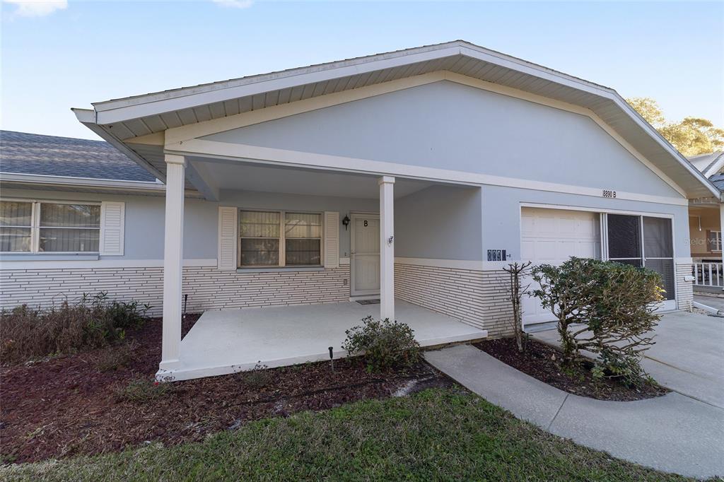 A spacious kitchen features light wood cabinets, stainless steel appliances, and wood-look flooring — 8890 SW 96TH STREET UNIT B, OCALA, FL