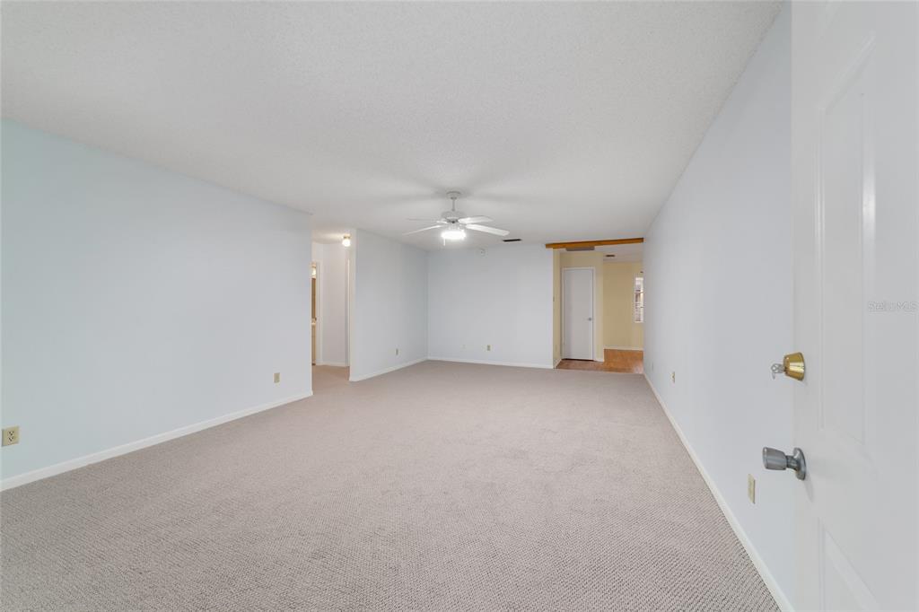 A light blue single-story house with a concrete driveway and a front lawn — 8890 SW 96TH STREET UNIT B, OCALA, FL