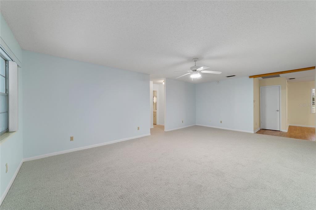 A light blue single-story house features a covered front porch and an attached garage — 8890 SW 96TH STREET UNIT B, OCALA, FL