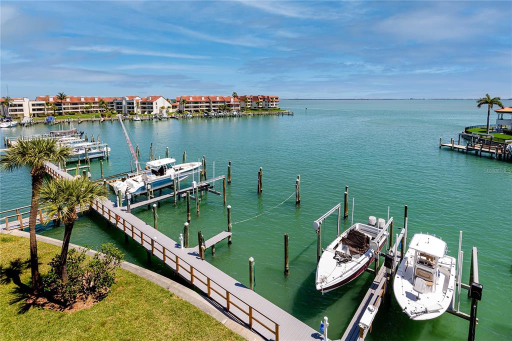 An elevated view of a marina with several boats docked at wooden piers — 363 PINELLAS BAYWAY S UNIT 48, TIERRA VERDE, FL