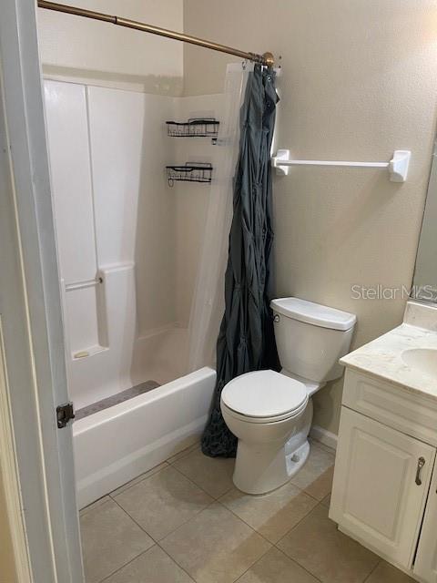 A bathroom features a white tub-shower combination, a toilet, and a white vanity cabinet — 38 PINE HURST LANE UNIT B, PALM COAST, FL