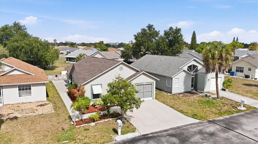 An aerial view shows a suburban street with single-story houses, driveways, and landscaped front yards — 4006 W 37TH STREET COURT W, BRADENTON, FL