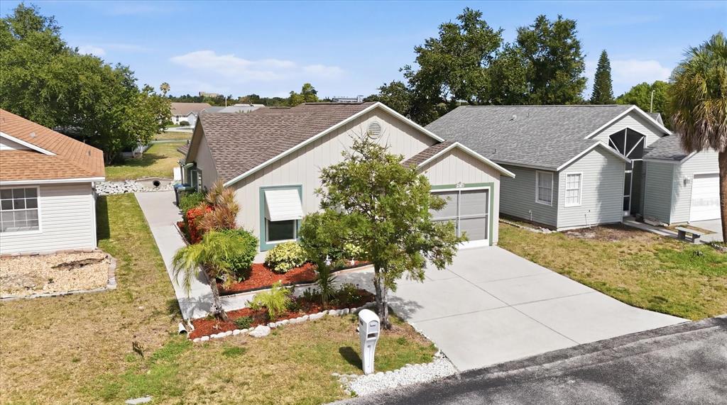 An aerial view of a single-story house with a concrete driveway and landscaped front yard — 4006 W 37TH STREET COURT W, BRADENTON, FL