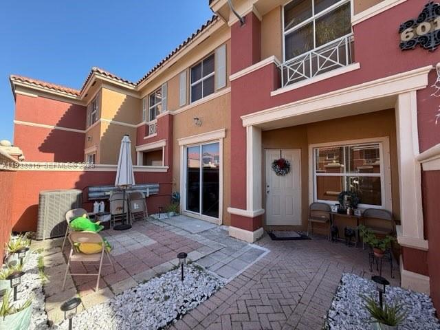 A patio area features a paved floor, white gravel landscaping, and a tan exterior wall — 6015 NW 116th Pl # 465, Doral FL 33178, DORAL, FL