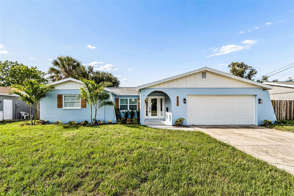A light blue single-story house with a white garage and a front lawn — 1101 54TH AVENUE S, ST PETERSBURG, FL