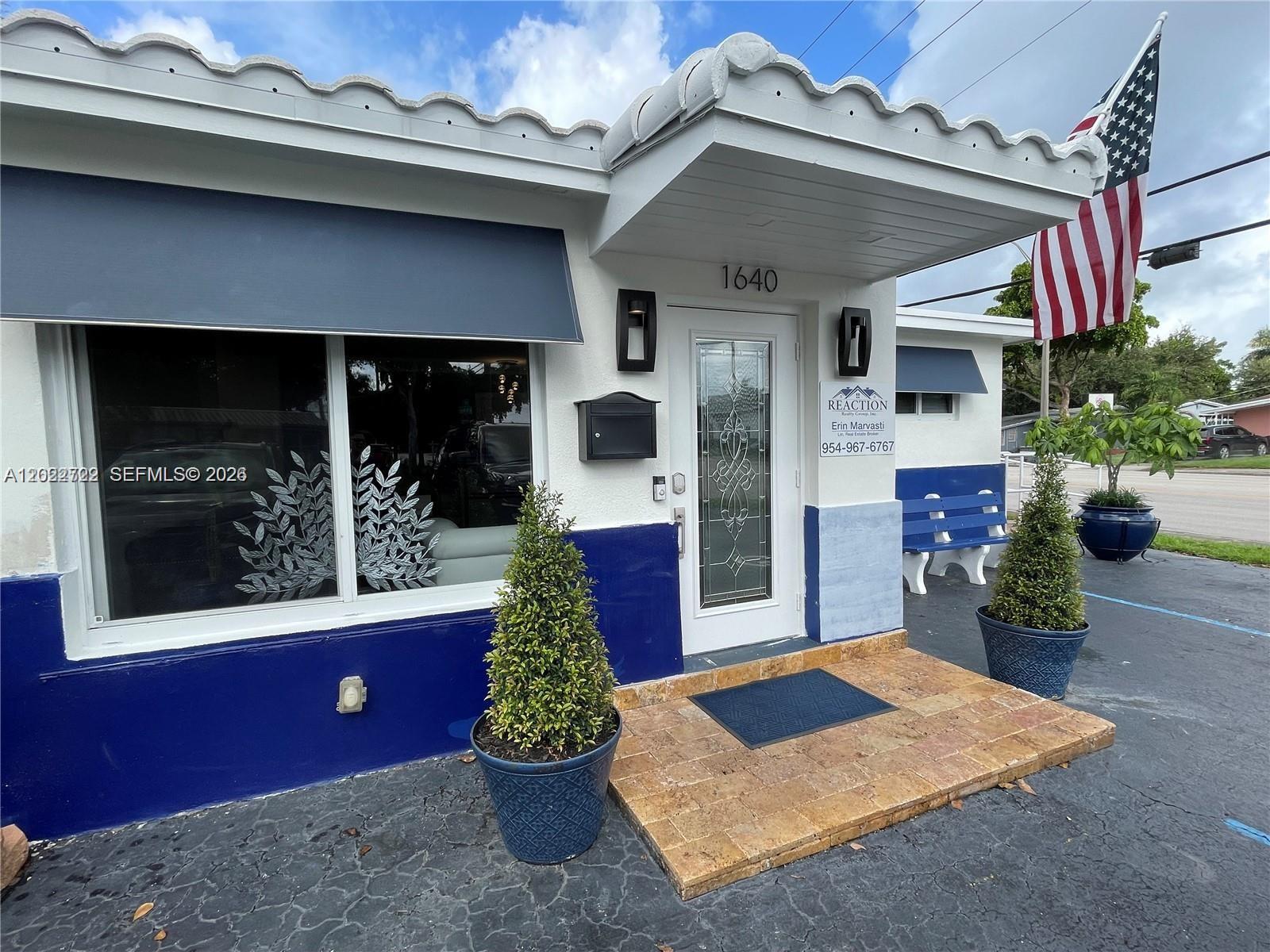 A white building with blue trim, a tiled entrance, and an American flag — 1640 N 70th Way, Hollywood FL 33024, HOLLYWOOD, FL