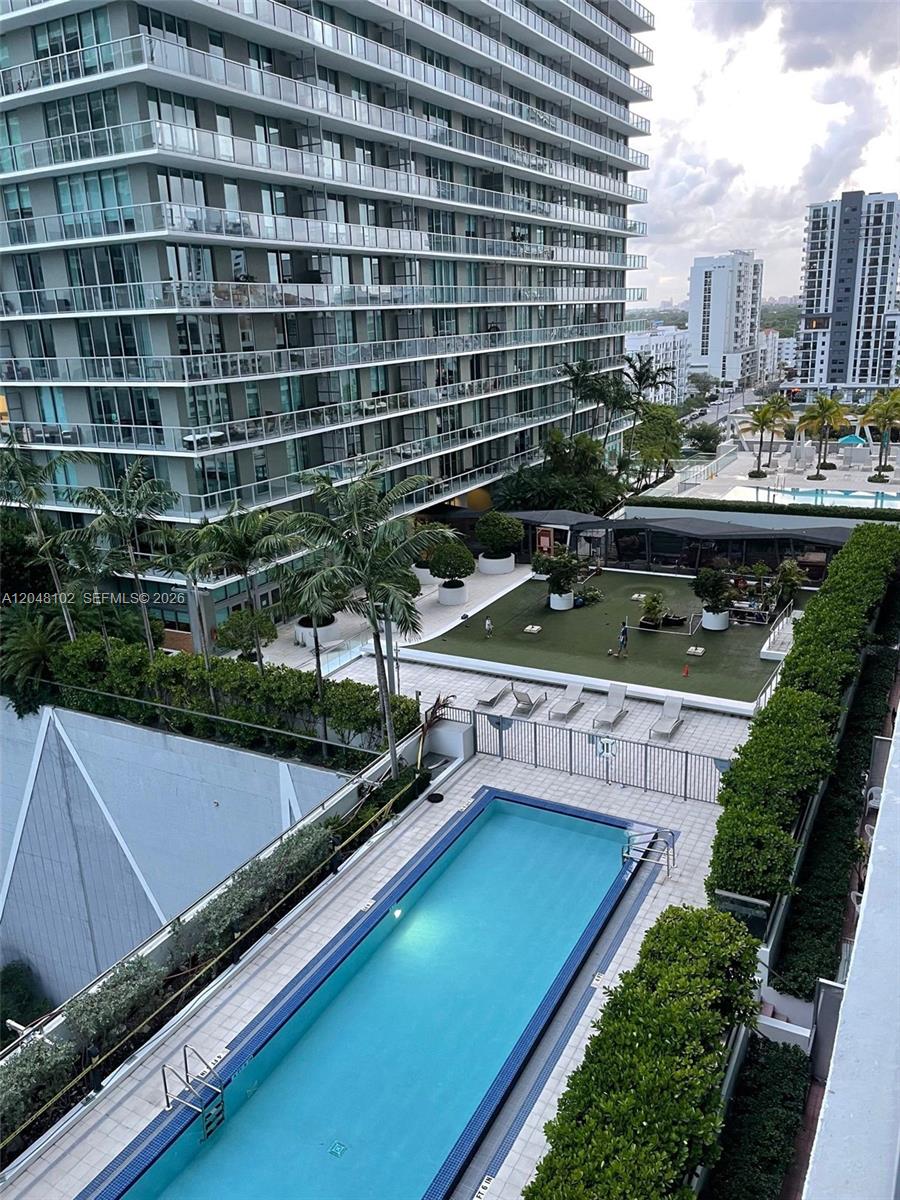 An elevated view shows a swimming pool, a green recreational area, and a tall building — 1111 SW 1st Ave, Miami FL 33130, MIAMI, FL
