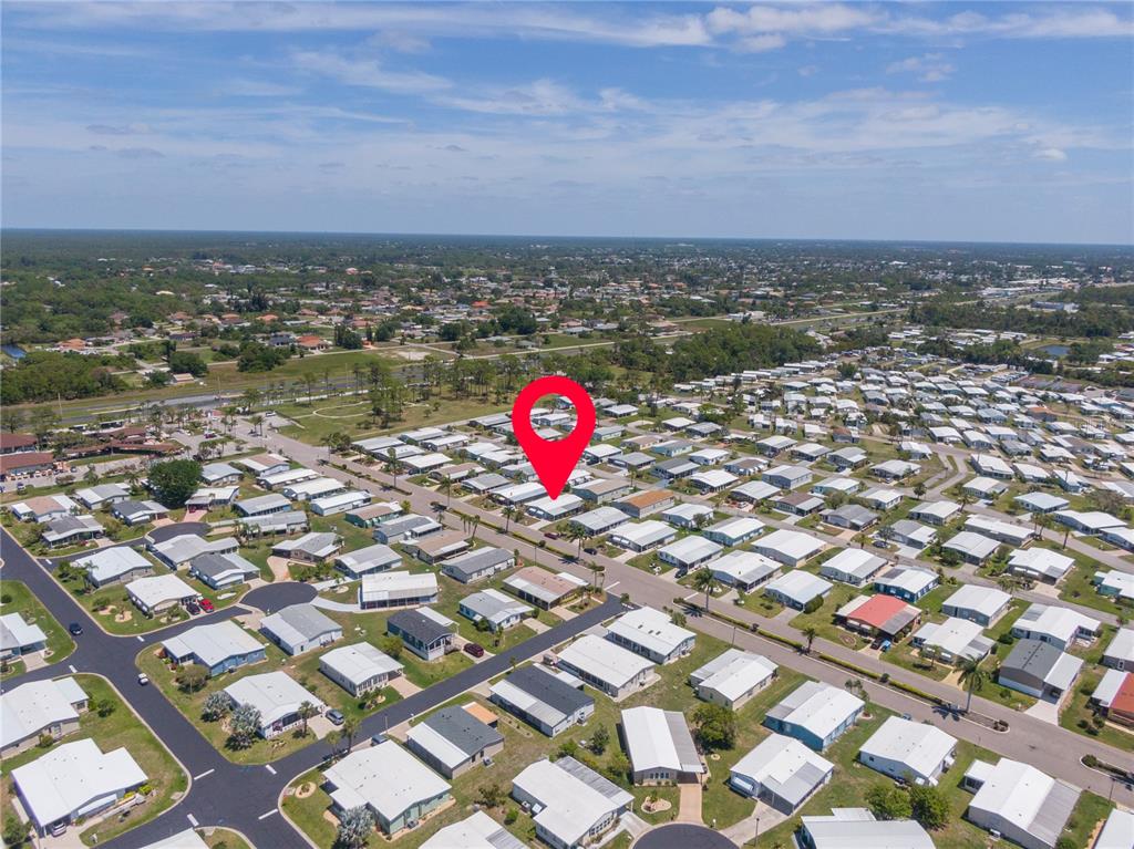 An aerial view shows a mobile home community with a red location pin — 172 PALM HARBOR DRIVE, NORTH PORT, FL