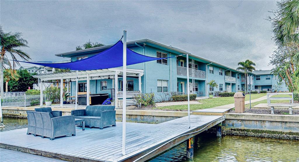 A view of a canal from a wooden boat dock with a blue shade sail — 300 VENETIAN DRIVE UNIT 2, CLEARWATER, FL