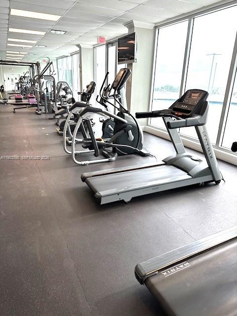 A gym room features several Matrix treadmills and elliptical machines on a dark rubber floor — 7135 Collins Ave # 722, Miami Beach FL 33141, MIAMI BEACH, FL