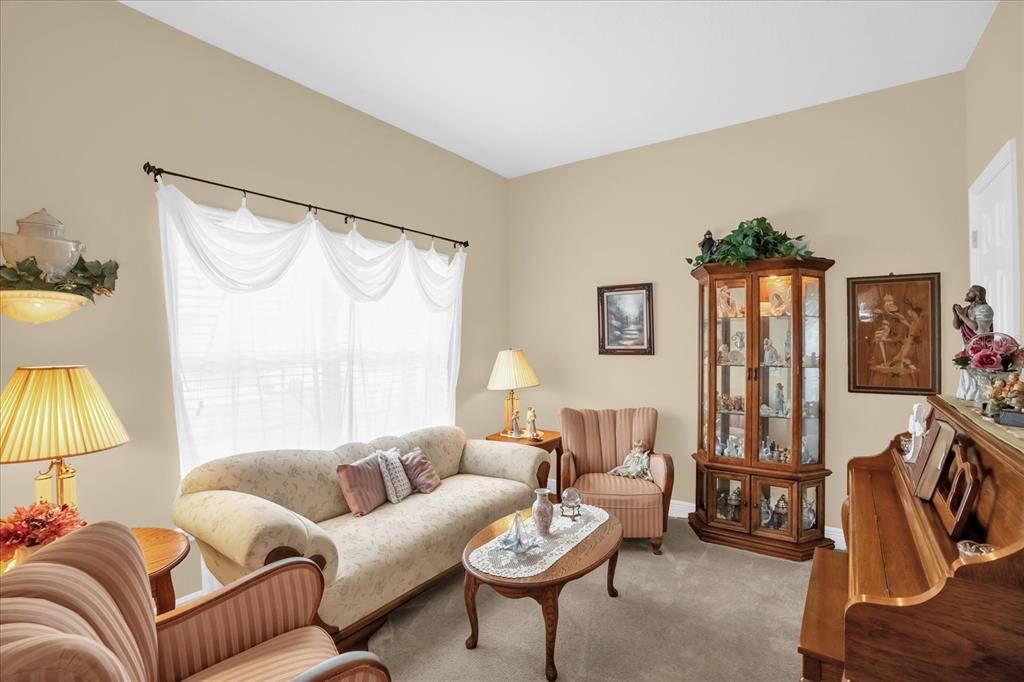 A living room features a sofa, two armchairs, a curio cabinet, and an upright piano — 1338 ALSTON BAY BOULEVARD, APOPKA, FL