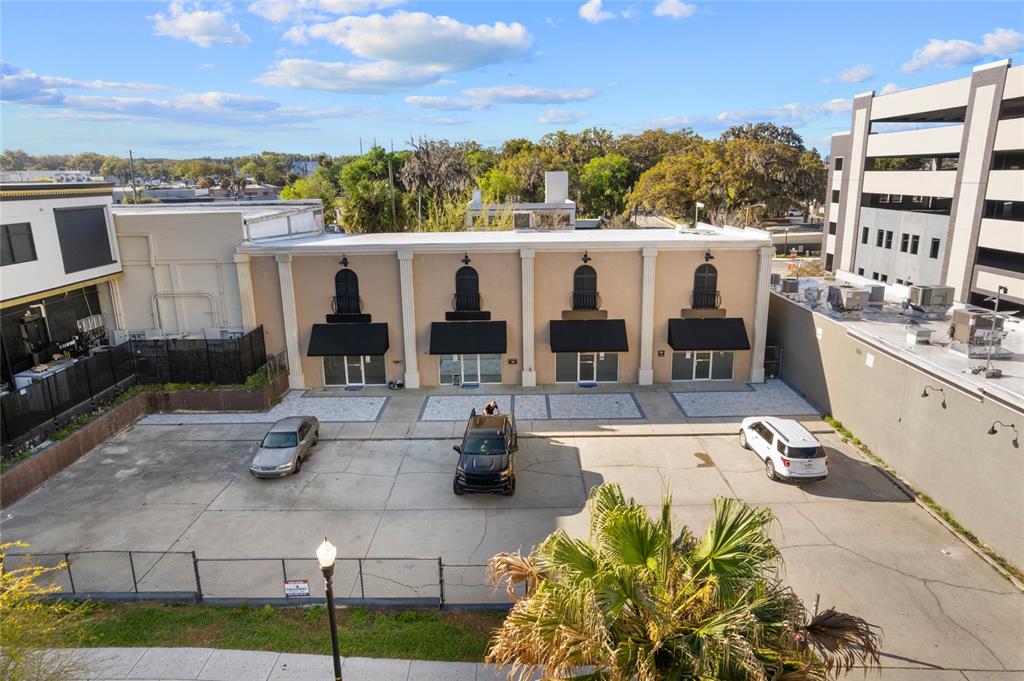 An exterior view shows a single-story commercial building with four storefronts and a paved parking lot — 120 SW BROADWAY STREET, OCALA, FL