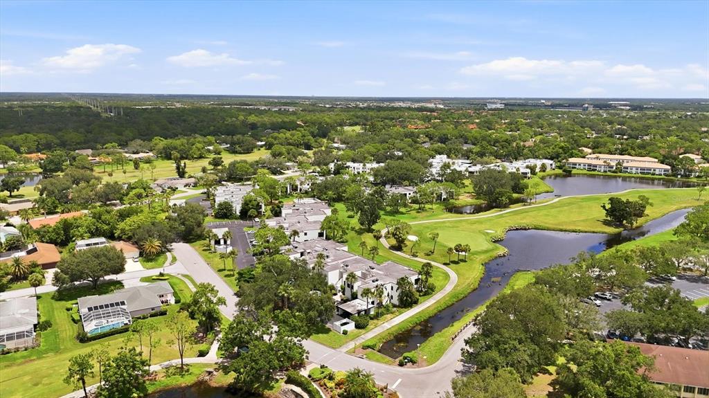An aerial view shows a residential community with multi-story buildings, a golf course, and ponds — 3508 RICHWOOD LINK UNIT 55, SARASOTA, FL