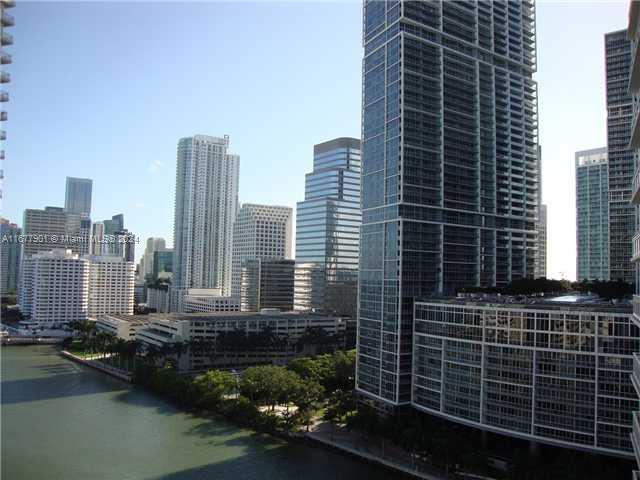 An elevated view of a city skyline featuring modern skyscrapers and a river below — 901 Brickell Key Blvd # 1701, Miami FL 33131, MIAMI, FL