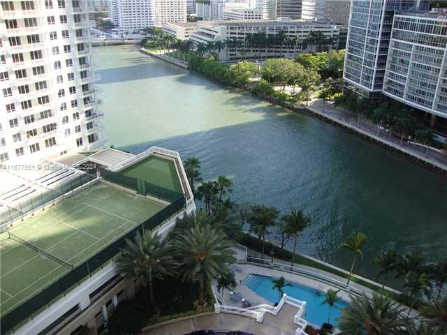 An elevated view of a tennis court, swimming pool, and a canal between high-rise buildings — 901 Brickell Key Blvd # 1701, Miami FL 33131, MIAMI, FL