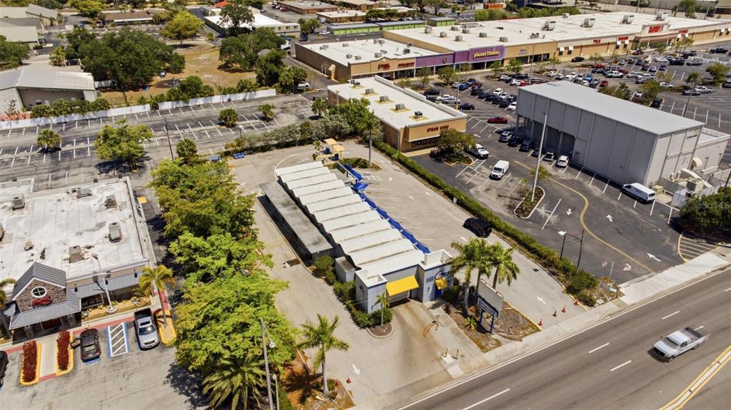 An aerial view shows a car wash facility situated in a commercial parking lot — 3821 CLEVELAND AVENUE, FORT MYERS, FL