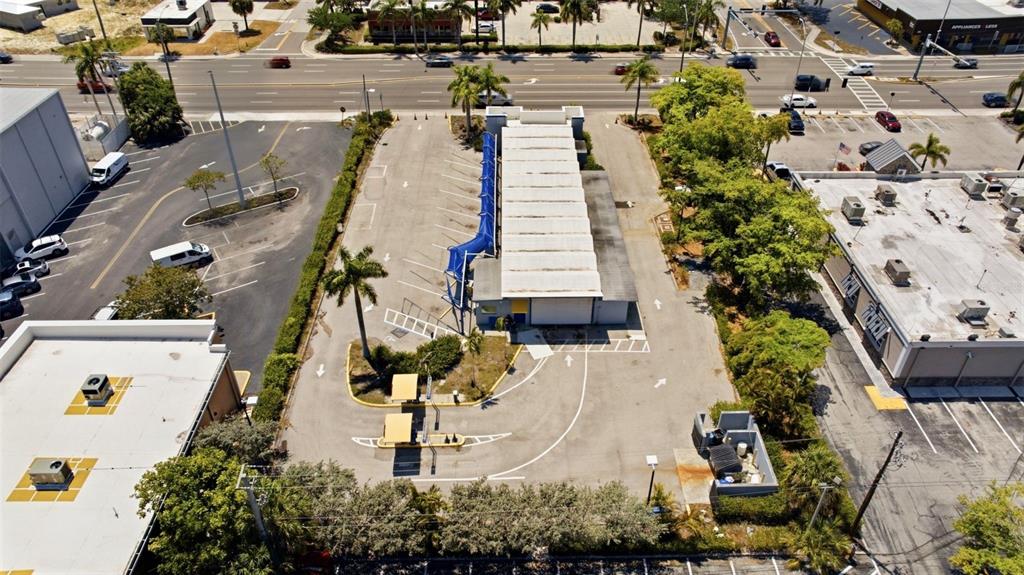 An aerial view shows a commercial car wash facility with a long building and parking — 3821 CLEVELAND AVENUE, FORT MYERS, FL