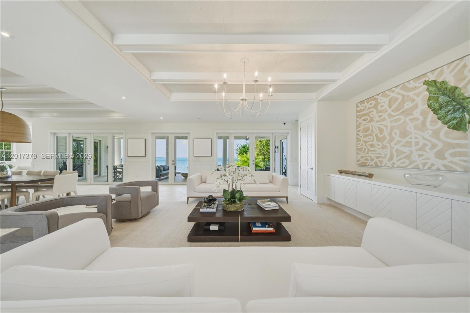 A bright, modern living room features white sofas, a dark coffee table, and ocean views — 75840 Overseas Highway, Islamorada FL 33036, ISLAMORADA, FL