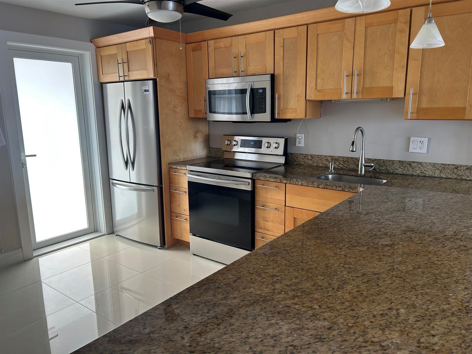 An elevated view of a swimming pool, patio, sandy beach, and the ocean — 750 N Ocean Boulevard # 1009, Pompano Beach FL 33062, POMPANO BEACH, FL