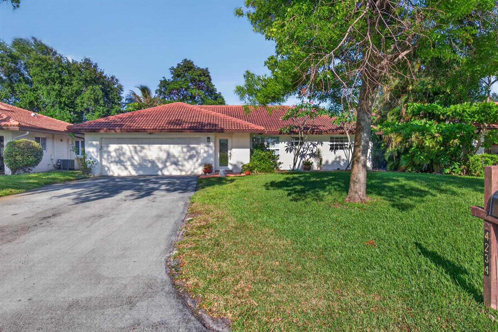 A single-story house with a red tile roof, white exterior, and a paved driveway — 4234 NW 3rd Way, Boca Raton FL 33431, BOCA RATON, FL
