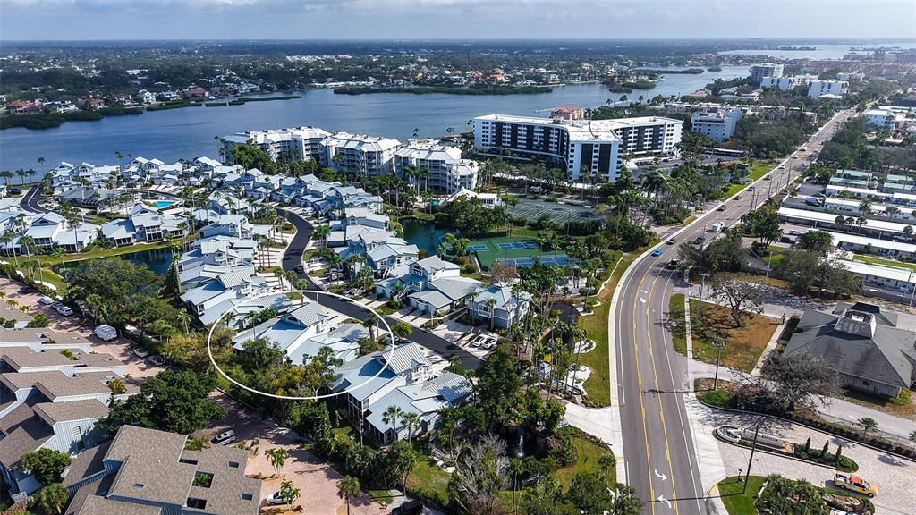An aerial view shows a residential complex with a circled building near a coastal waterway — 1225 SIESTA BAYSIDE DRIVE UNIT 1225B, SARASOTA, FL